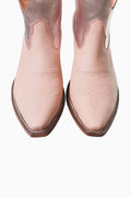 Pair of pink cowboy boots on a white background