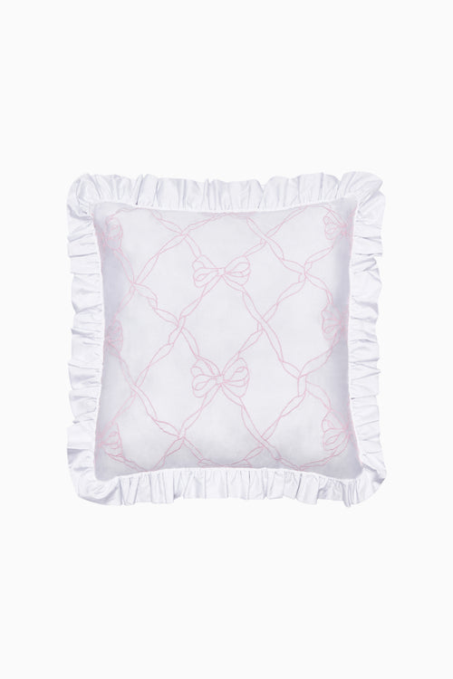 White pillow with ruffled edges and pink embroidery on a white background