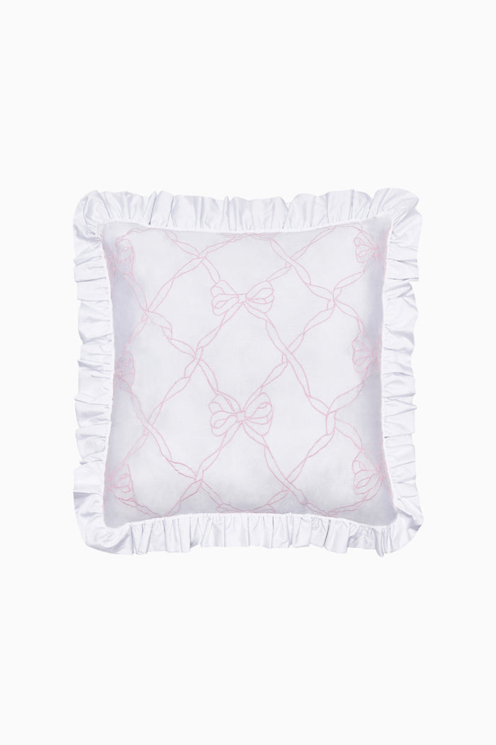 White pillow with ruffled edges and pink embroidery on a white background