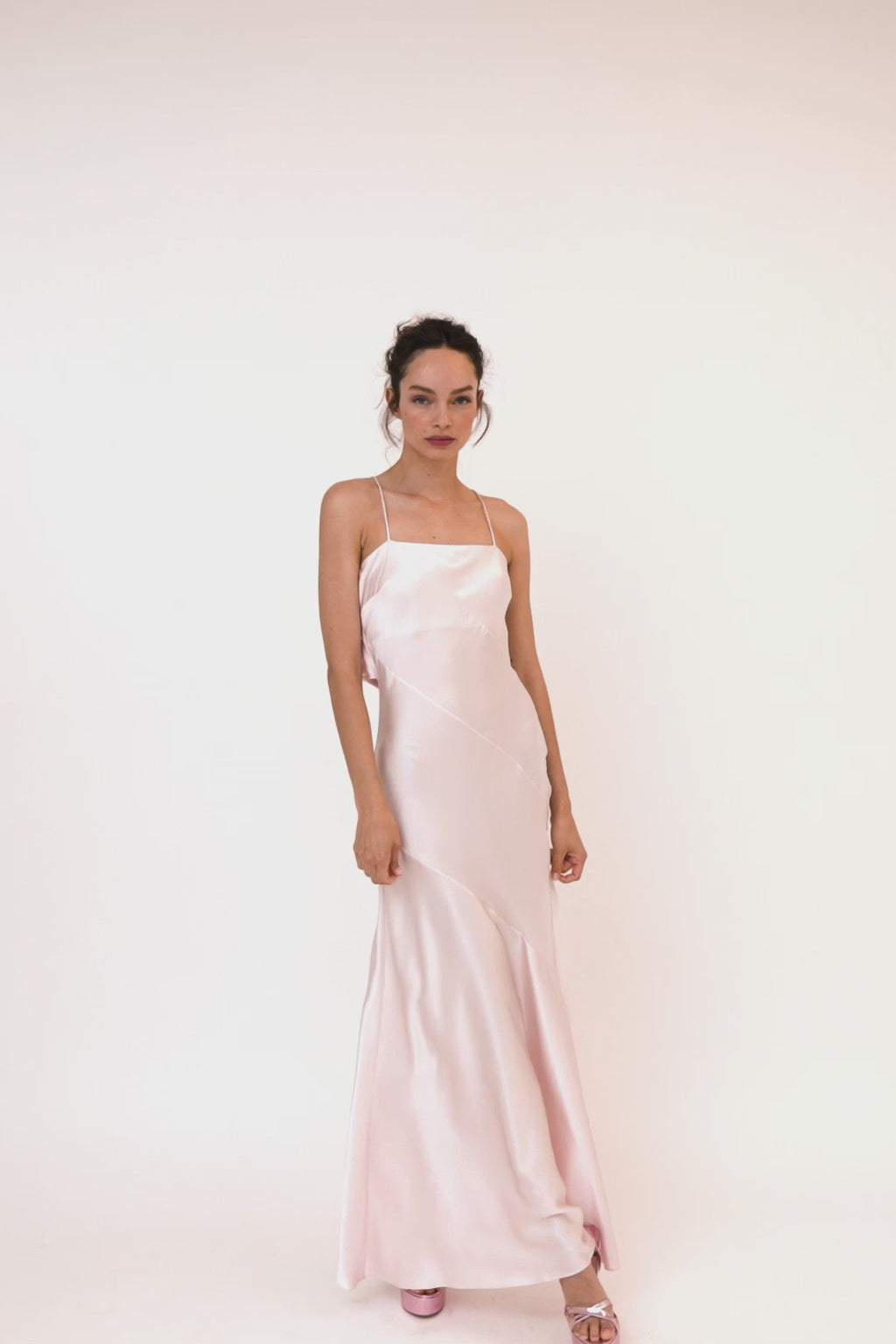  The Oaklynn Maxi Dress is 100% pink silk and features a sweeping silhouette, adjustable spaghetti straps, asymmetrical seams, and a scoop back with a large bow   OAKLYNNDRESS- MACCHIATO