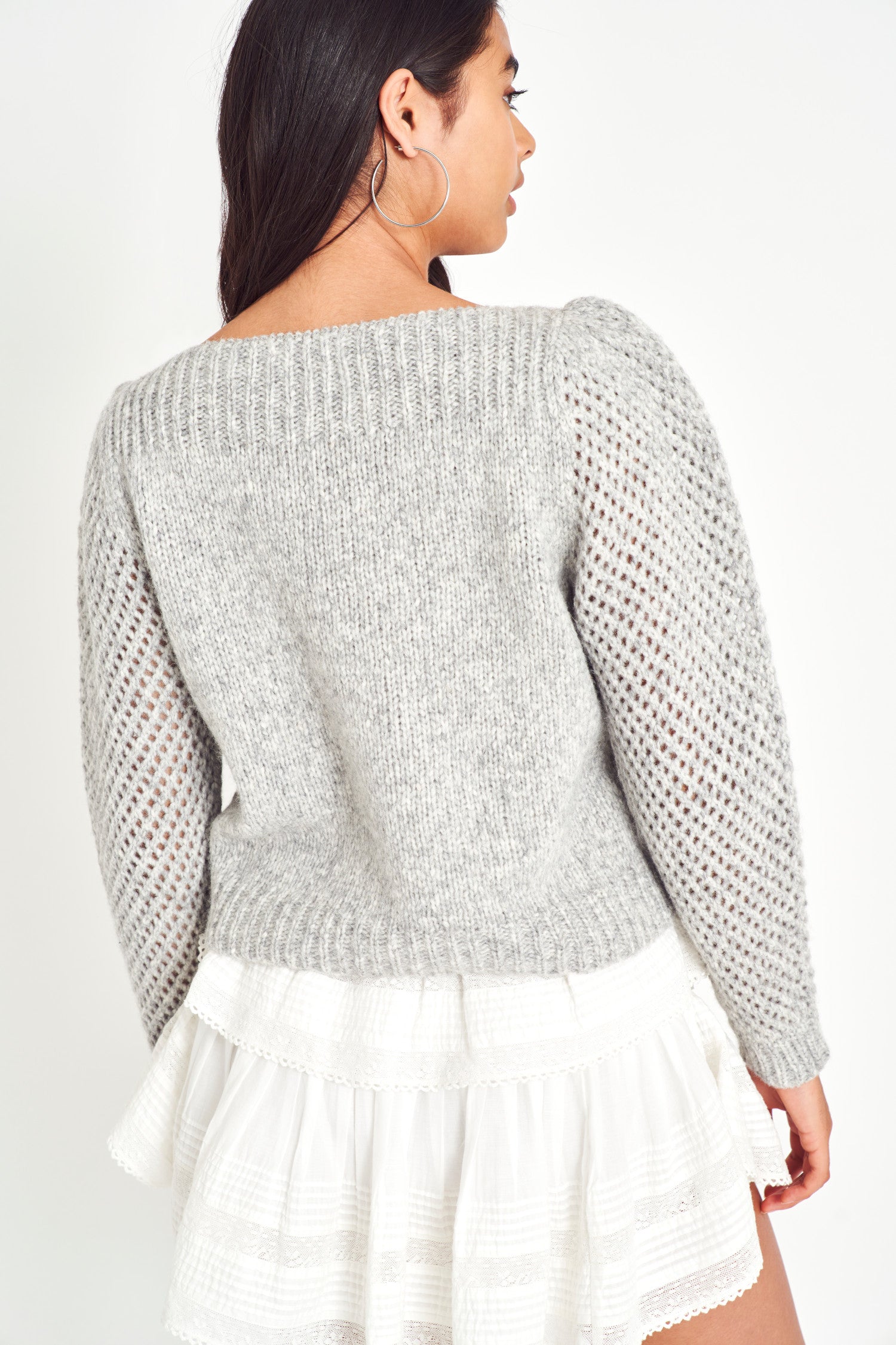 The Rosie pullover is made from baby alpaca while being extremely light and full with a chunky look. It has a straight rib neckline and a straight body with rib finishing. It is an open knit weave with a puffy shoulder that slims out at the bottom.