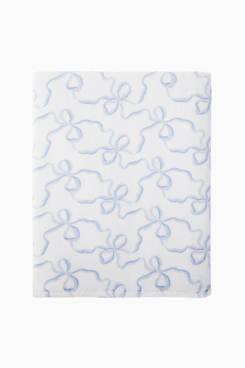 White towel with blue bow pattern on a white background