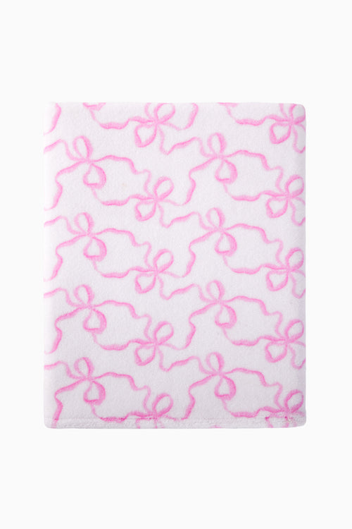 White towel with pink bow pattern on a white background