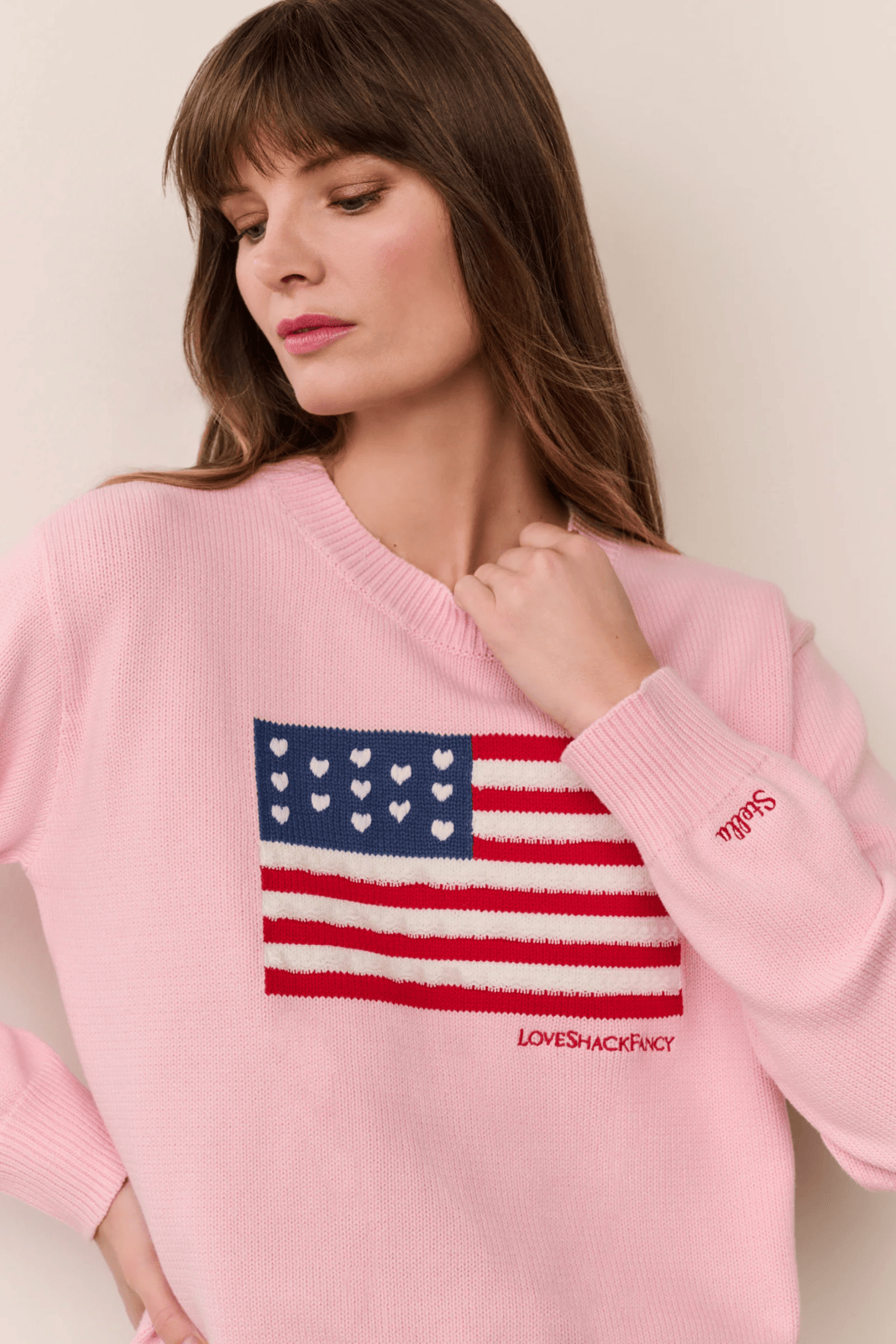 Women sitting in grass field wearing LoveShackFancy Slip Dresses