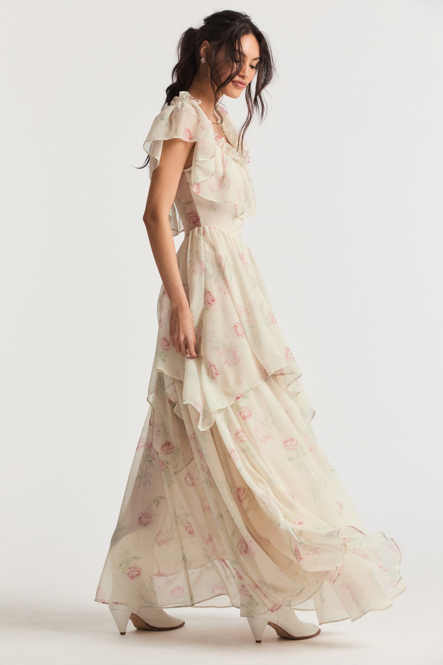 Cream maxi dress with elastic off-the-shoulder silhouette, ruffles around the neck, and a shaped skirt with ethereal tiers.