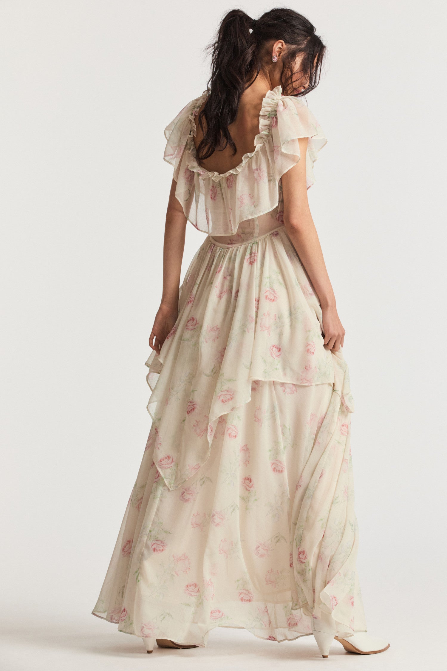 Cream maxi dress with elastic off-the-shoulder silhouette, ruffles around the neck, and a shaped skirt with ethereal tiers.