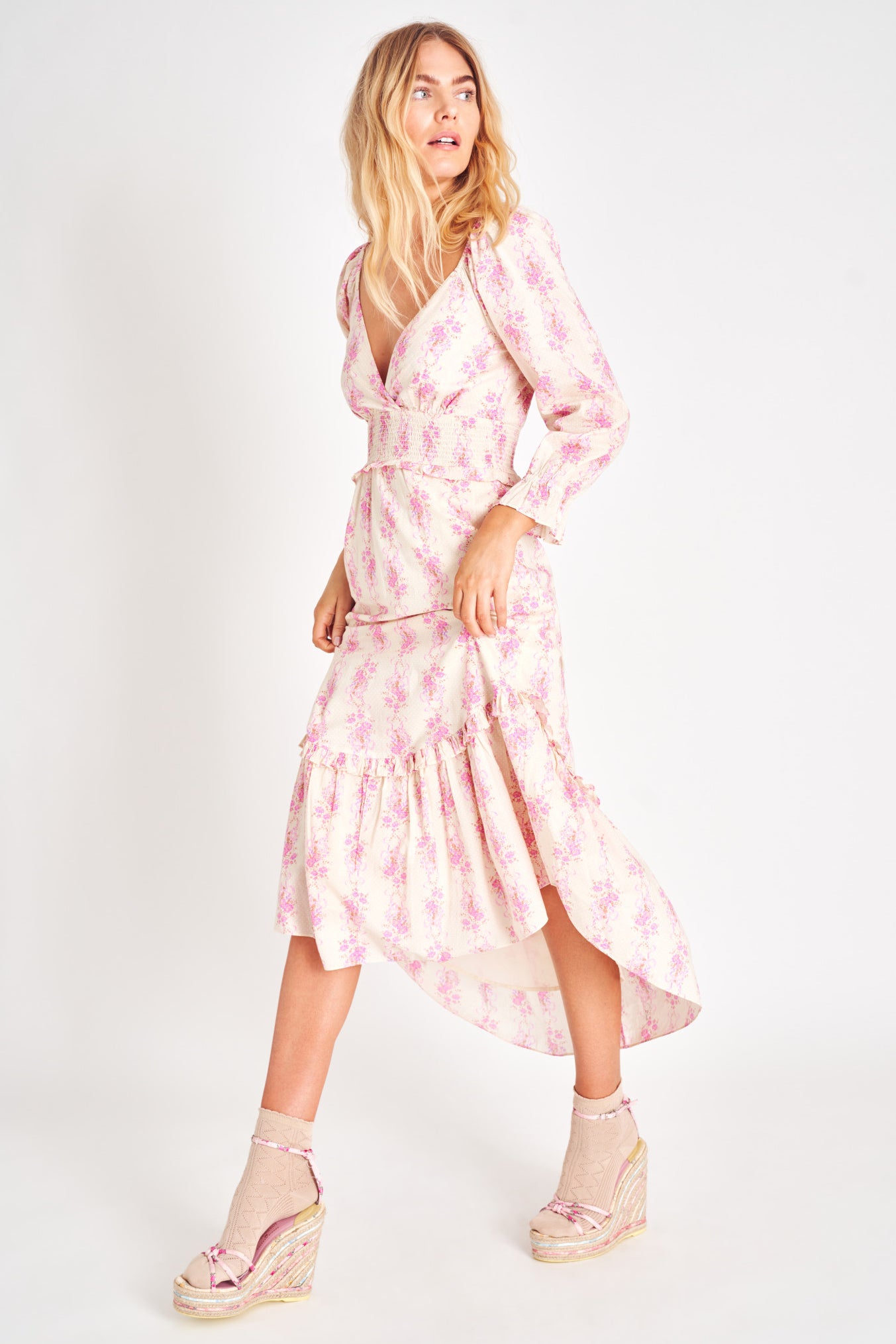 Long sleeve pink floral plunging v neck midi dress with smocked waist.