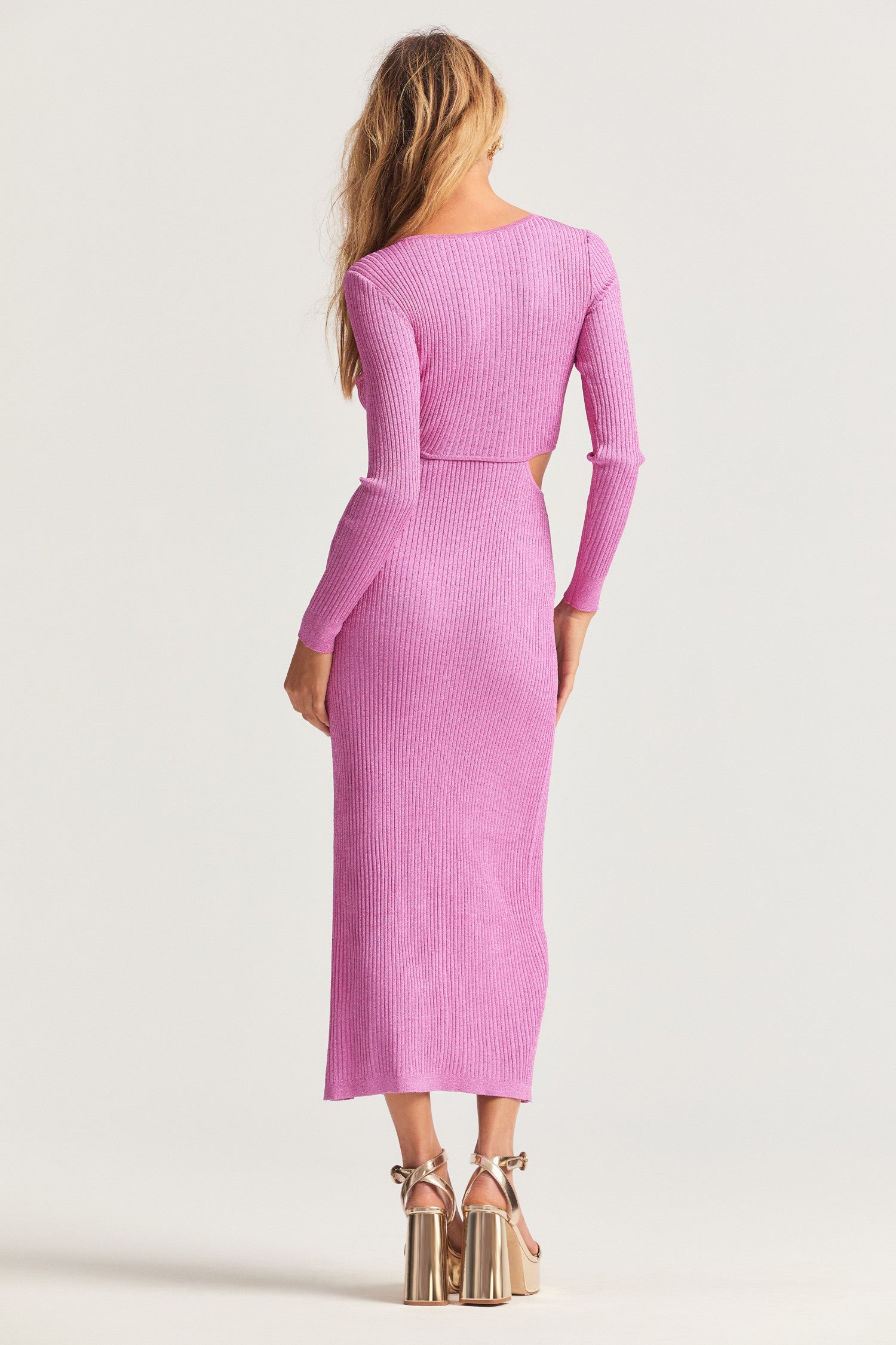 Midi dress with soft yarn, completely plated with lurex so it shimmers all over. This ribbed knit, fitted dress has a stretchy, comfy fit with a twist detail at the center front that leads to flirty cut-outs on each side. In addition to a slit at the wearer's left. 