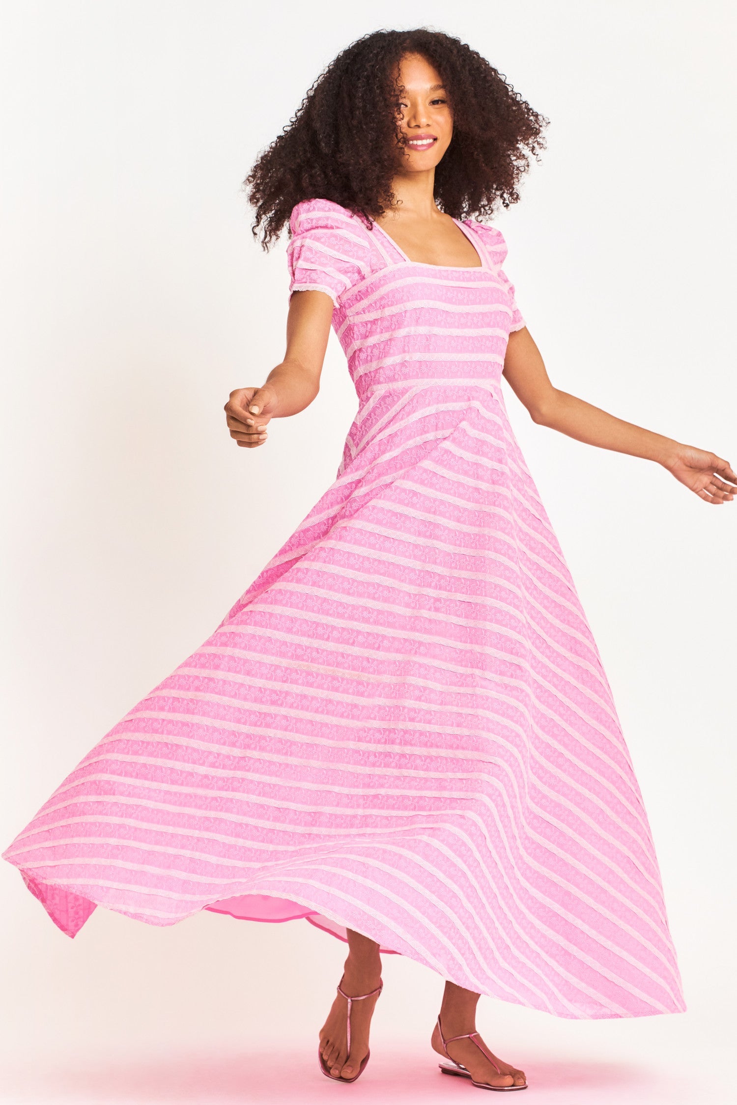 Pink floral lace maxi dress features a square lace neckline with a fitted bodice and short puff sleeves