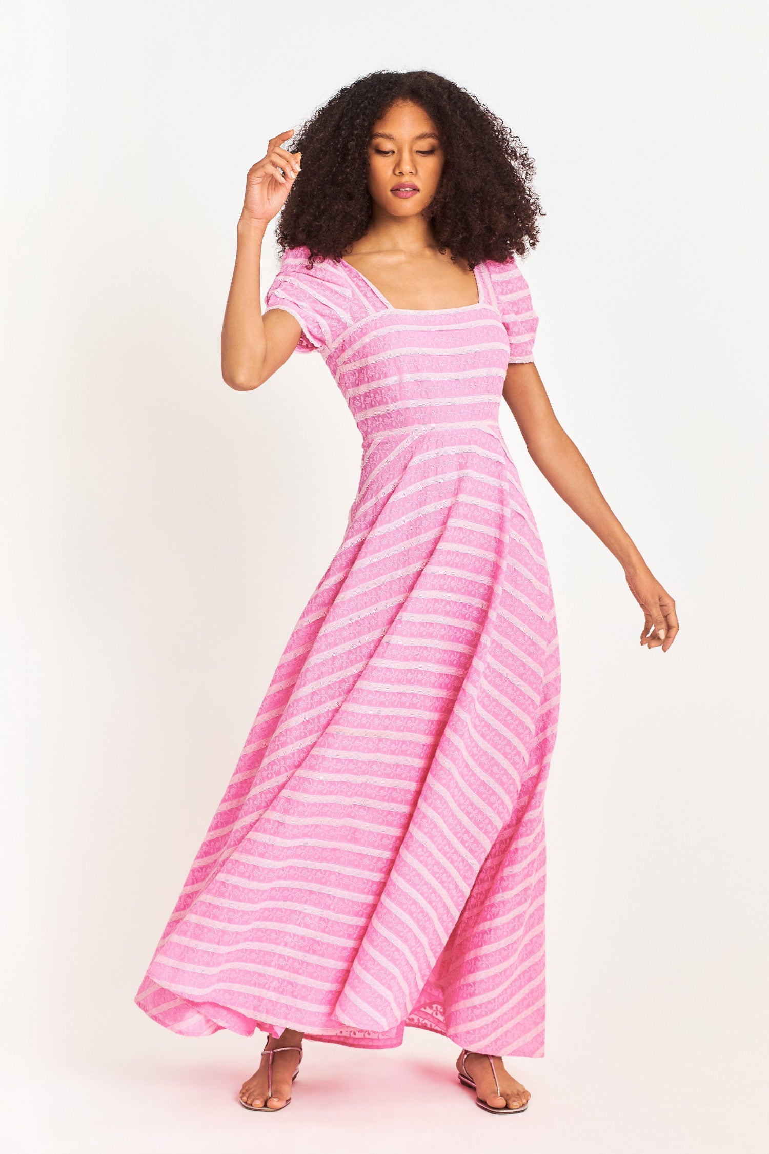 Pink floral lace maxi dress features a square lace neckline with a fitted bodice and short puff sleeves