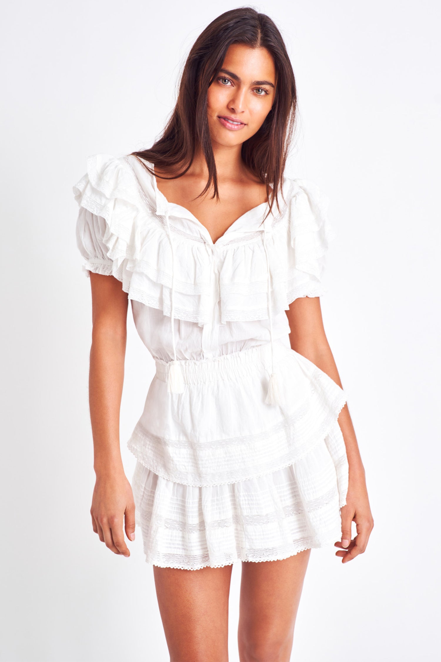 The Liv dress is a vintage inspired dress and features a puff sleeve and a double tiered yoke top. It has a ruffled mini skirt which brings in a feminine look along with front ties to finish the scoop neckline, and a cinched elastic waist. 
