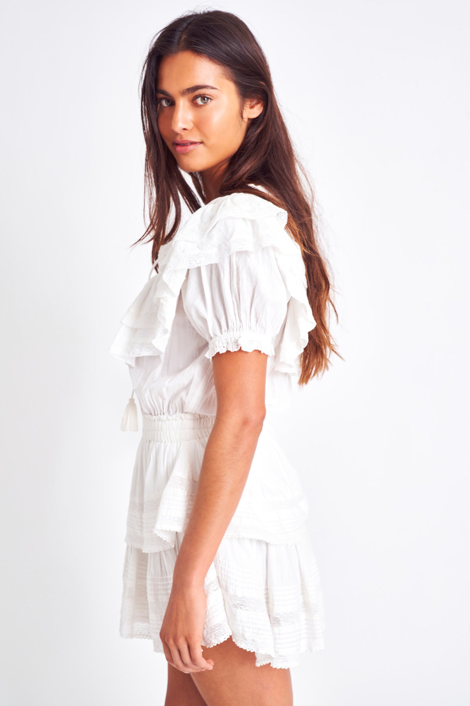 The Liv dress is a vintage inspired dress and features a puff sleeve and a double tiered yoke top. It has a ruffled mini skirt which brings in a feminine look along with front ties to finish the scoop neckline, and a cinched elastic waist. 