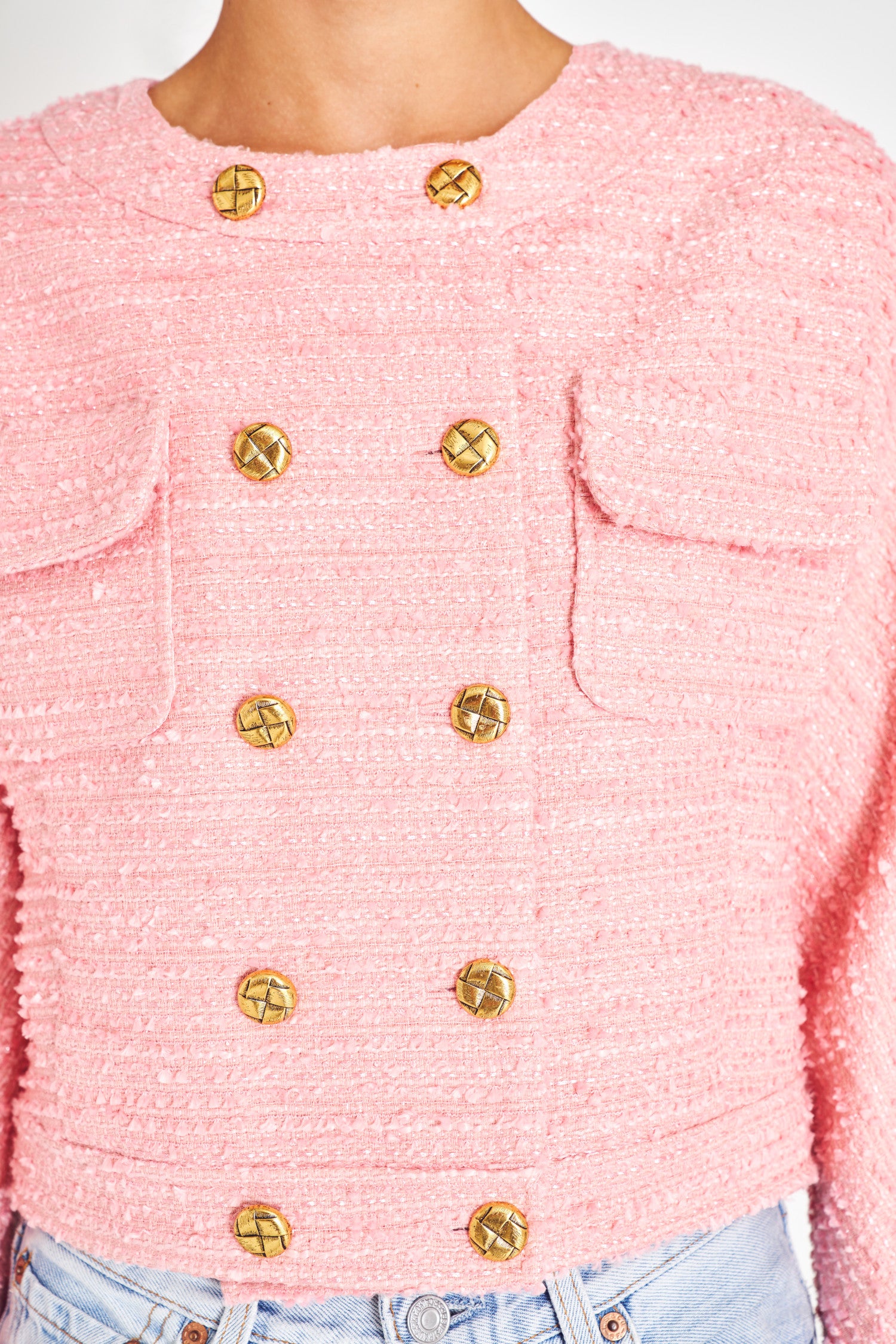 Pink tweed double breasted jacket with gold buttons.
