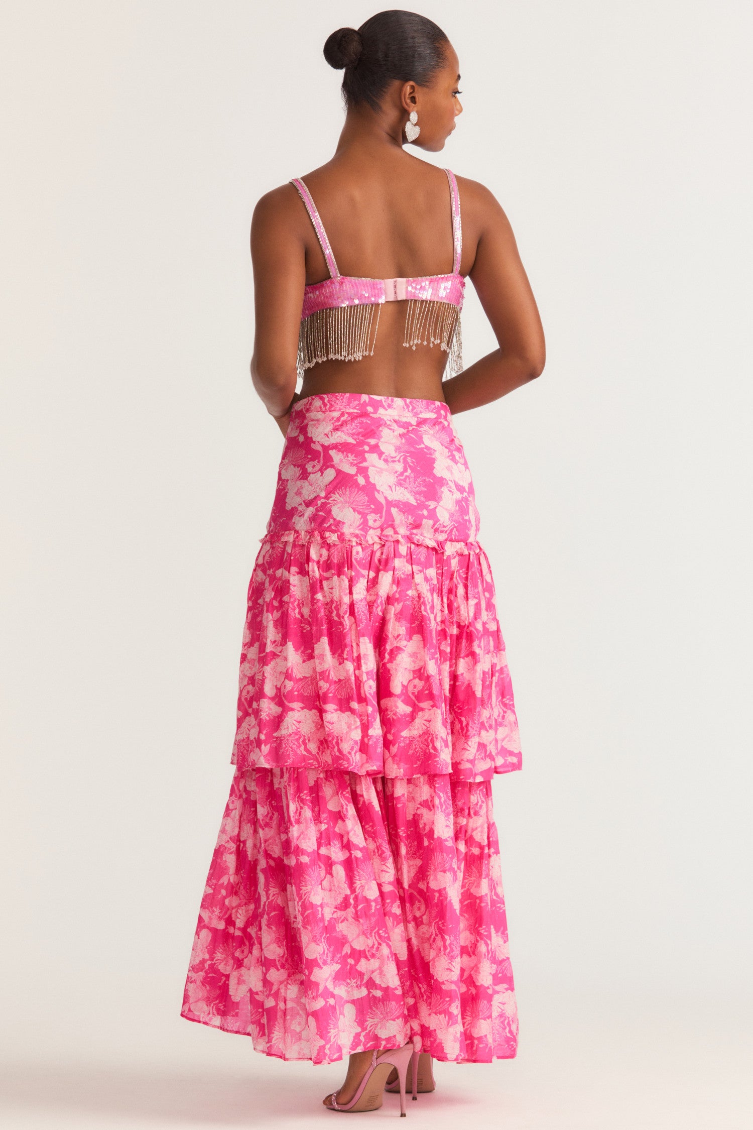 Womens pink floral cotton silk maxi skirt with leg slit and ruffle detailing.
