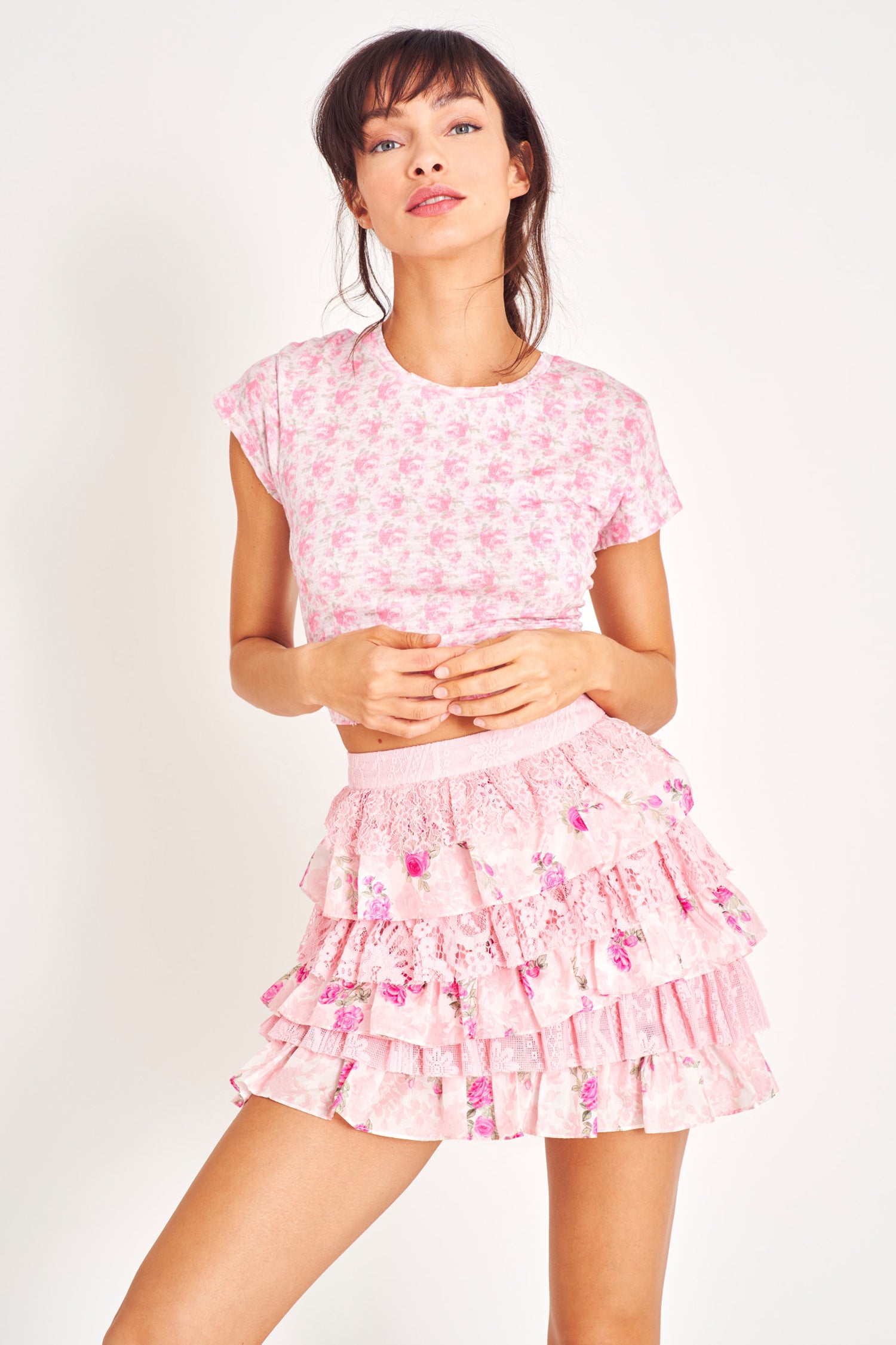 Ruffle pink mini skirt with lace and floral prints, and elastic waistband.