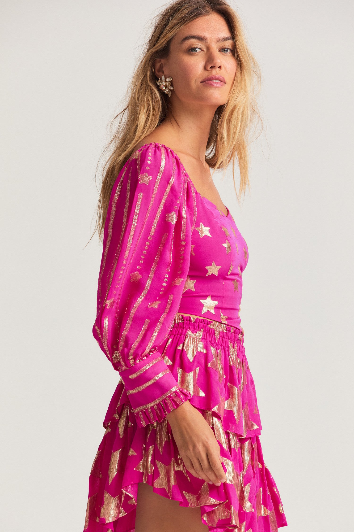 Pink viscose fabric blouse with metallic, gold star detailing. Romantic bishop sleeves with elastic at the shoulder openings. 