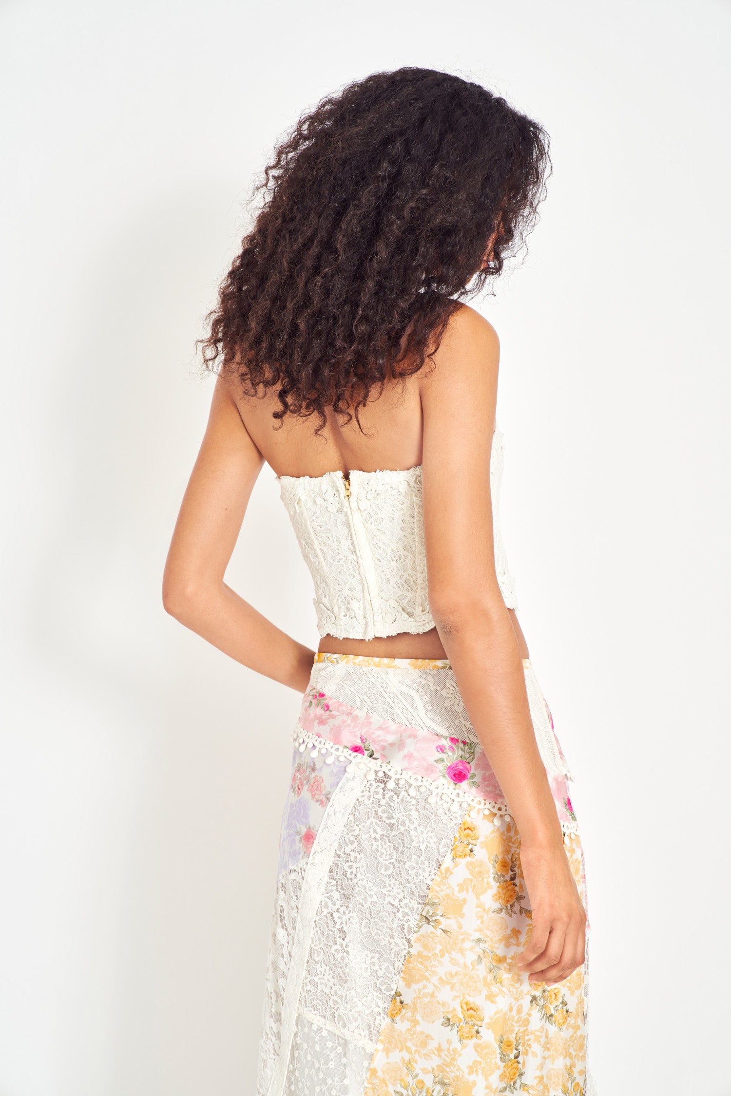 White lace bustier with floral applique.