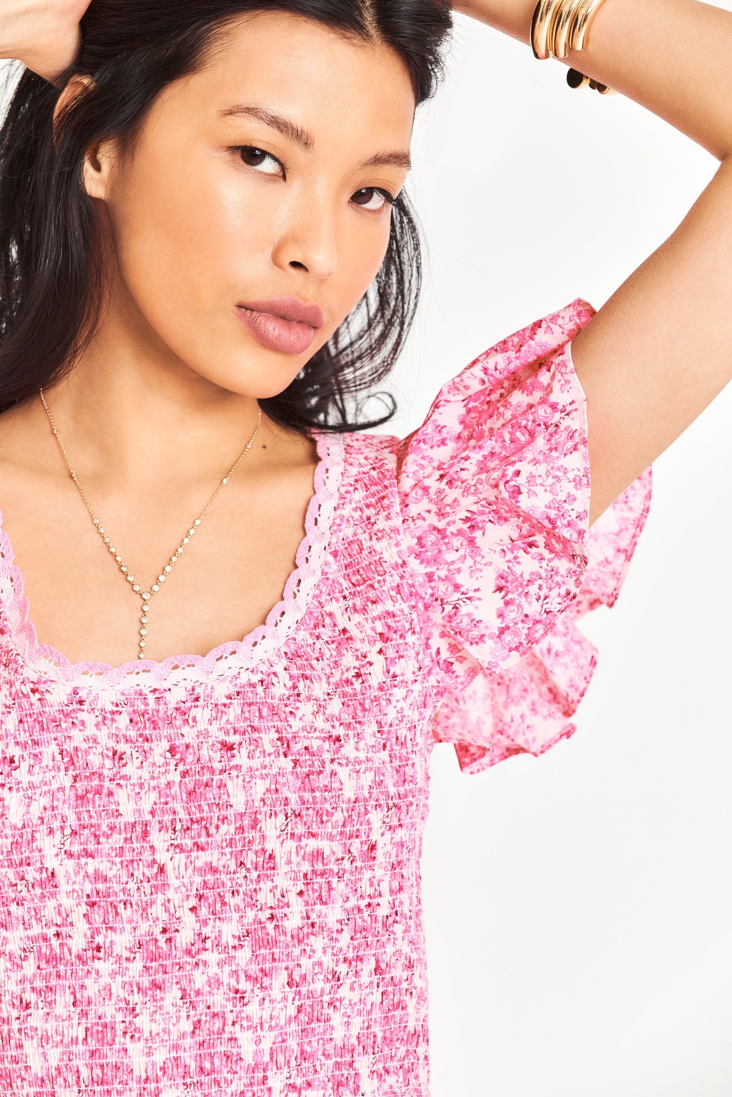 Pink smocked floral top with flutter sleeves
